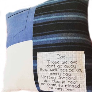 May include: A white and blue striped cushion with a white patch and a blue denim patch. The cushion has a white embroidered patch with the text "Dad Those we love don't go away. They walk beside us. Every day. Unseen, unheard, but always near, so loved, so missed, so very dear."
