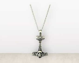 May include: Silver necklace with a detailed Mjolnir pendant featuring a skull design.