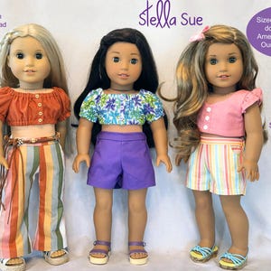 Peut inclure: Trois poupées vêtues de tenues faites à la main. Les poupées portent un haut court rouille et un pantalon rayé, un haut court floral et un short violet, et un haut court rose et un short rayé. Les tenues sont conçues pour les poupées de 45,7 cm.