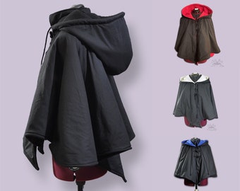 May include: Black hooded cape with a contrasting colour lining. The lining is available in red, white, or blue. The cape is made of a soft, comfortable fabric and has a drawstring closure at the neck.