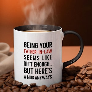 May include: White coffee mug with a black rim and handle. The mug has black text that reads "Being your Father-in-Law seems like gift enough... But here's a mug anyways".