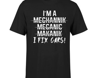 May include: Black t-shirt with white text that reads "I'm a MECHANIK MECHANIC MAKANIK I FIX CARS!"