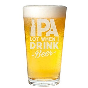 May include: A clear pint glass filled with golden beer and a foamy white head. The glass has the words "IPA", "LOT WHEN I DRINK", and "Beer" etched into the glass in a white font, along with a bottle graphic.