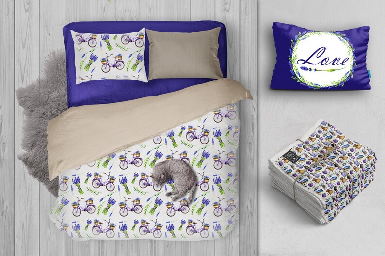 May include: A white bedding set featuring a lavender and bicycle design. The set includes a duvet cover, two pillowcases, and a decorative pillow with the word "Love" in a wreath of lavender.