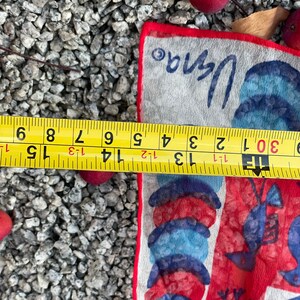 May include: A white cotton handkerchief with a red, blue, and white design of lobsters and seashells. The handkerchief is 15 inches long and 8 inches wide. The text "Vana" is printed in the top right corner.