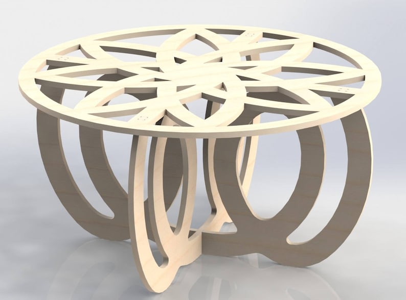 May include: A light-colored wooden coffee table with a circular top featuring a decorative cutout design. The table has a unique base composed of curved, interlocking supports. The table is approximately 18 inches tall and 36 inches in diameter.