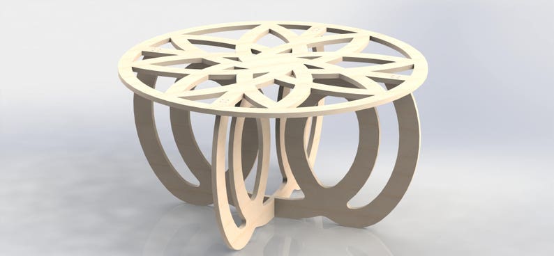 May include: A light-colored, wooden coffee table with a decorative, openwork design on the tabletop. The table has a round top and curved legs, creating a modern and artistic look. The table is approximately 24 inches in diameter.
