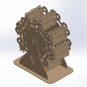 May include: A brown, laser-cut Ferris wheel photo display. The display has four photo frames with the word "PHOTO" on each. The design includes decorative swirls and a heart-shaped cutout on the base. The display is made of cardboard.