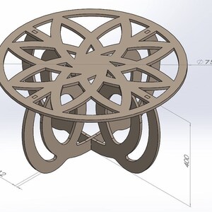 May include: A brown, laser-cut wooden table with an intricate floral design on the tabletop. The table is 29.5 inches in diameter and 15.7 inches tall. The table's base has a unique, curved design. The tabletop is 0.5 inches thick.