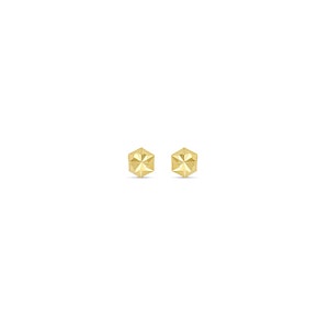 May include: A pair of gold-toned stud earrings with a geometric, faceted design.