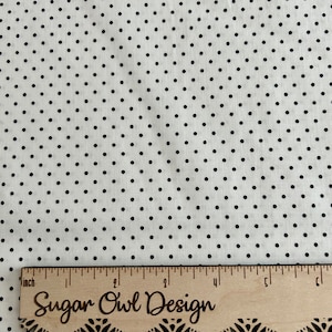 May include: White fabric with a black polka dot pattern. A wooden ruler with the text "Sugar Owl Design" is at the bottom of the image.