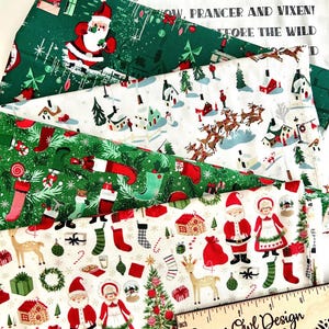 May include: A collection of Christmas-themed fabric patterns. Designs include Santa Claus, reindeer, stockings, and holiday text on a white and green background. A wooden ruler with the text "Sugar Owl Design" is also visible.