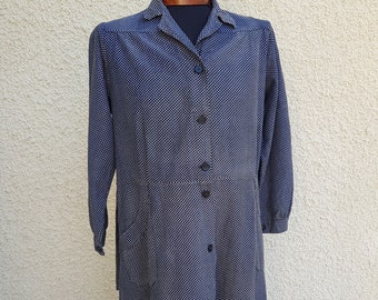 May include: A long-sleeved, button-up dress with a white and blue geometric pattern. The dress has a collared neckline and a slightly flared skirt.