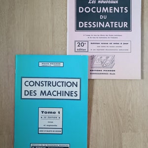 Può includere: Due libri francesi vintage. Uno è intitolato "Les nouveaux DOCUMENTS DU DESSINATEUR" in testo bianco su sfondo verde scuro. L'altro libro è intitolato "CONSTRUCTION DES MACHINES" in testo bianco su sfondo turchese. Entrambi i libri sono su una superficie marrone chiaro.