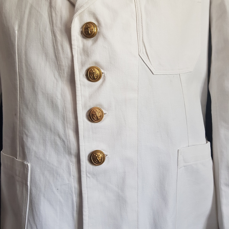 May include: White jacket with four gold buttons featuring an anchor design.