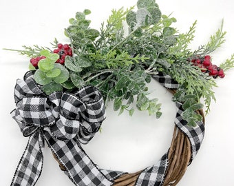 Christmas and Holiday Wreath Candle Holder,  with White and Black Buffalo Plaid Bow, Eucalyptus Branches and Red Berries on Grapevine Base