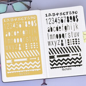 May include: A yellow stencil with white numbers, letters, symbols, and patterns. The stencil is on a white page with a black grid pattern. The text "Tibetara" is printed on the stencil.