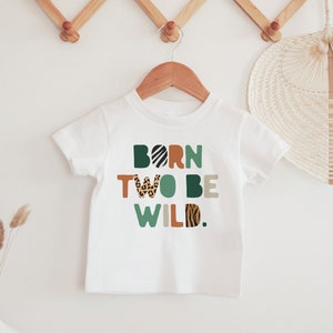 May include: White t-shirt with the text "BORN TWO BE WILD." in colorful letters with animal print patterns.