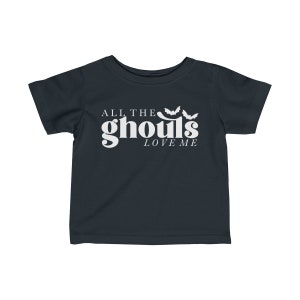 May include: A dark blue toddler t-shirt with white text that reads "All the ghouls love me" and three white bat silhouettes.