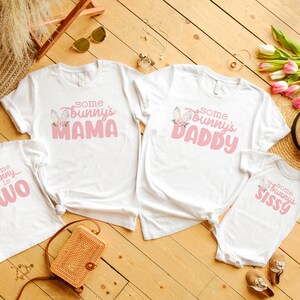 May include: Four white t-shirts with pink bunny graphics and text. The shirts say "Some Bunny is Two", "Some Bunny's Mama", "Some Bunny's Daddy", and "Some Bunny's Sissy".