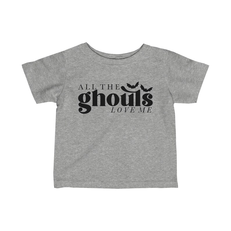 May include: A gray short-sleeved t-shirt with black text that reads "All the ghouls love me" and a graphic of three bats.