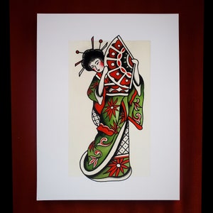 May include: A traditional Japanese geisha illustration with a green and red kimono, holding a red and white fan. The geisha has black hair with a red and white hair ornament.