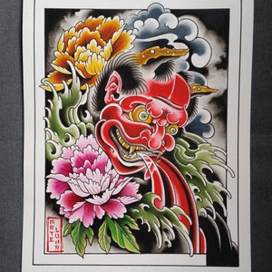 May include: A traditional Japanese tattoo design featuring a red oni mask with sharp teeth and green eyes, surrounded by stylized waves and pink and yellow peonies. The design is framed by a black border and includes the Japanese text "Sayuri".