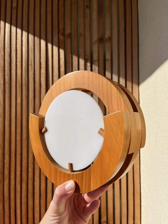 Round pine and plexiglass wall light, 1970