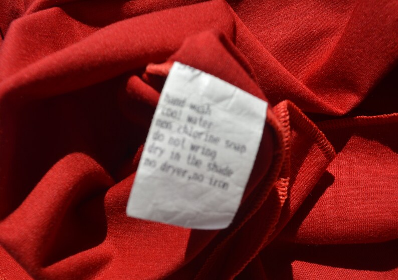 May include: A white care label with instructions for hand washing in cool water, no chlorine bleach, no wringing, drying in the shade, and no dryer or ironing.