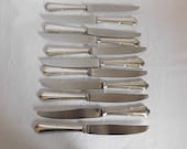 Suite of eleven knives French Louis XV pattern outlines punch DF stainless steel blade