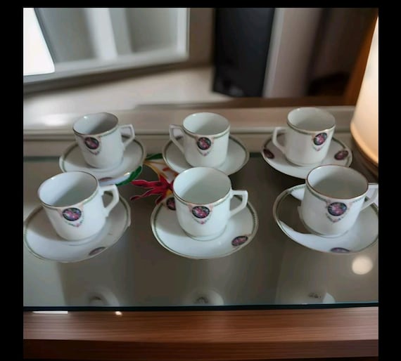 Porcelain coffee service part six cups and saucers floral decoration including roses