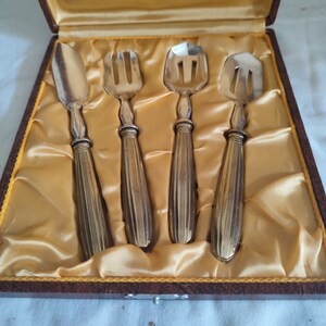 Knife, fork and two spades set with silver metal handles
