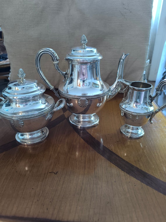 Durousseau & Raynaud three-piece silver-plated coffee service with shell and pearl decoration, sugar bowl, creamer