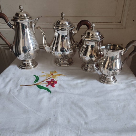 Four-piece silver metal coffee tea set with acanthus decoration and rows of pearls