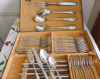 Part of a Louis Schooman silver-plated dessert and serving set. 54-piece cutlery set with shell and rockery decoration.