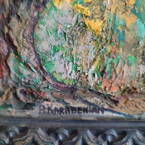 May include: A close-up of a textured, abstract painting with green, yellow, and brown colors. The painting is signed "D. Karapetkian" in the lower right corner.