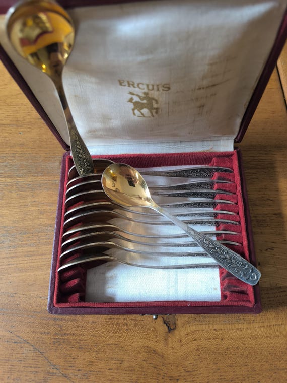 Set of twelve small silver and gold metal spoons, Russian USSR, foliage decoration in a box