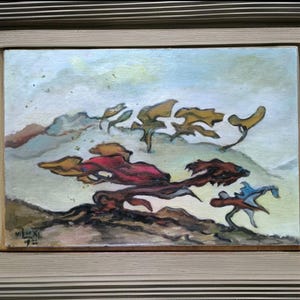 May include: An abstract landscape painting in a wooden frame. The artwork features stylized trees and foliage in shades of red, yellow, and blue against a light blue and beige background. The painting is signed in the lower left corner.