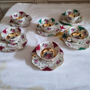 Set of six German porcelain mocha coffee cups and saucers decorated with roses and gilding