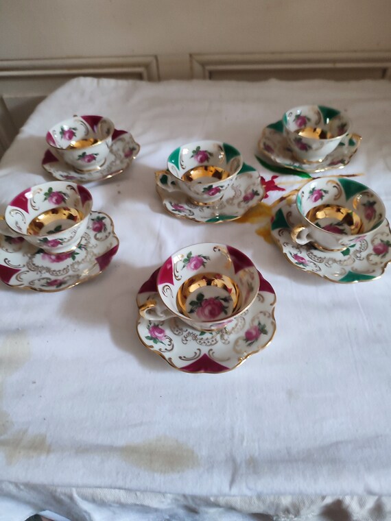 Set of six German porcelain mocha coffee cups and saucers decorated with roses and gilding