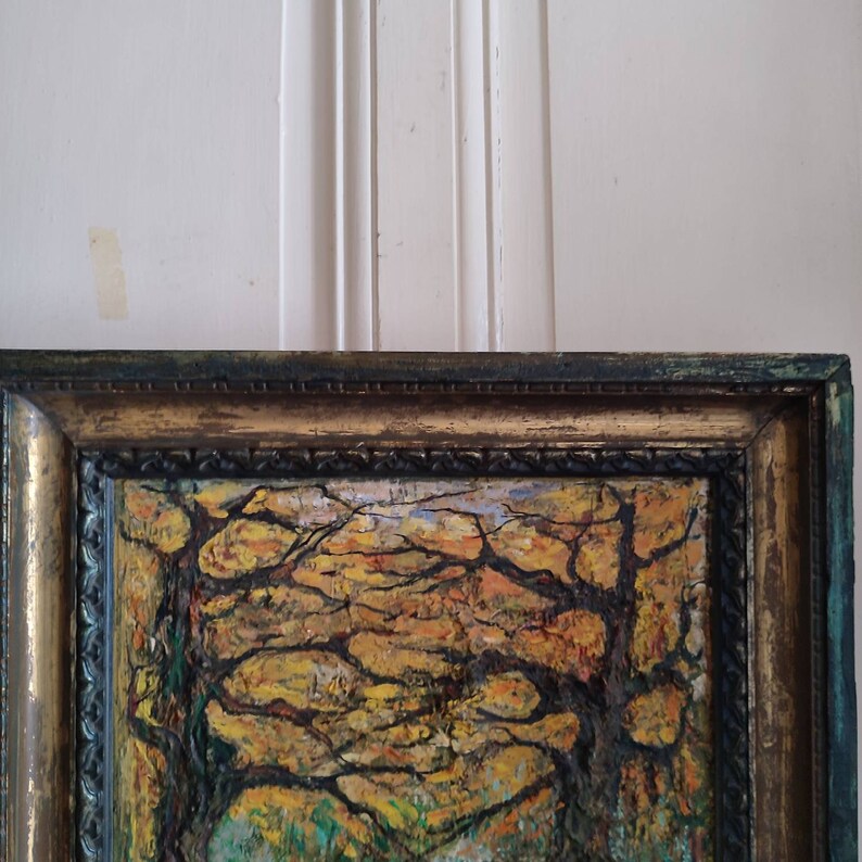 May include: A framed oil painting depicting a forest scene with trees in autumn colors. The trees have bare branches with yellow, orange, and brown leaves. The painting is framed in a dark wood frame with gold accents.