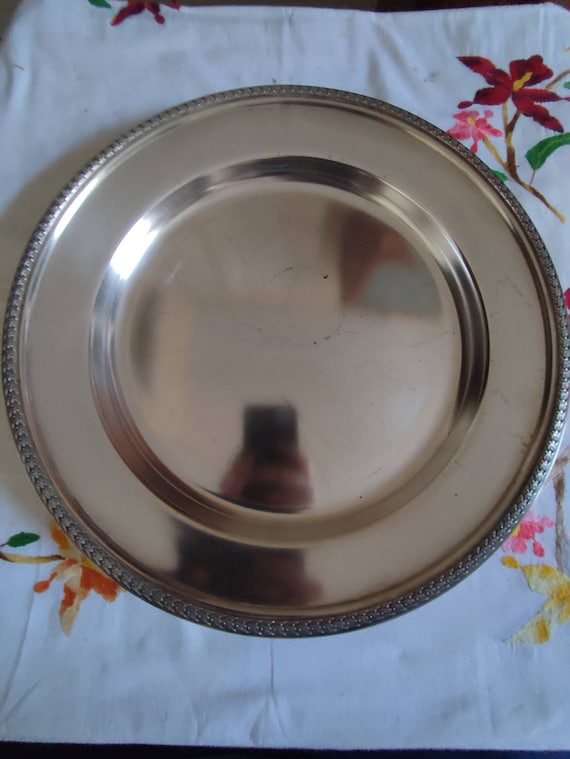 Large round silver metal tray decorated with rows of ears of corn