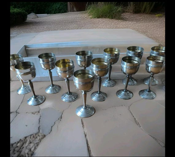 Liqueur service with twelve silver-plated metal glasses decorated with crossed ribbons and threads