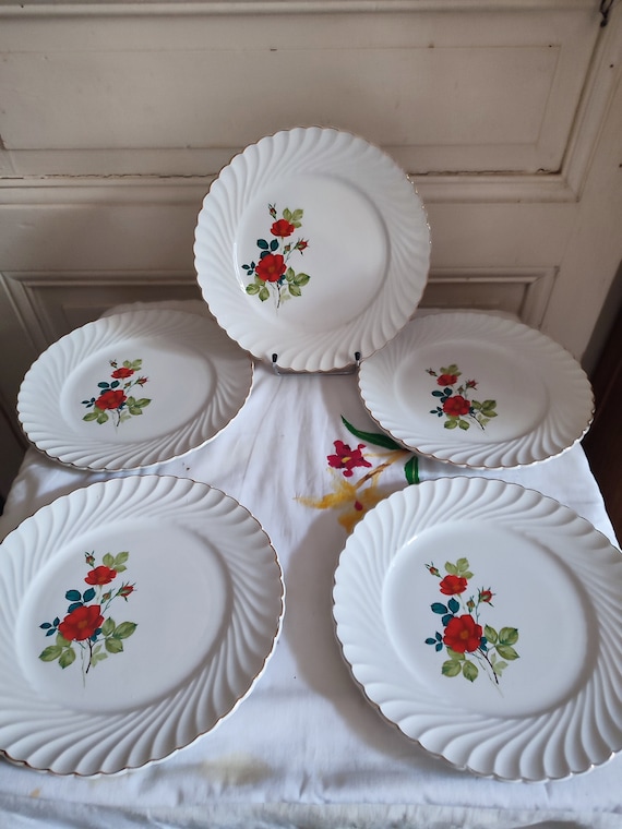 Five Keller & Guérin earthenware dinner plates decorated with flowers, traditional French earthenware model