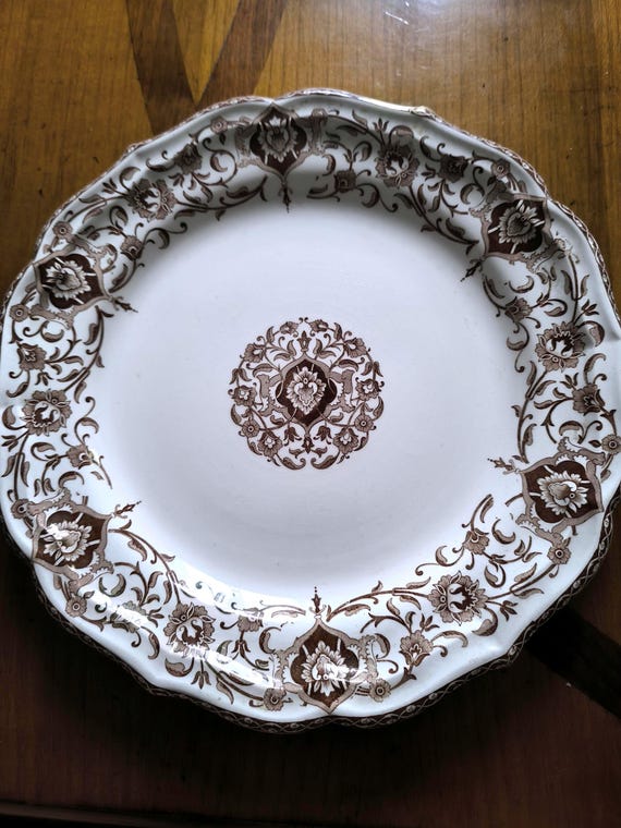 Gien earthenware round serving dish with brown decoration and floral scrolls
