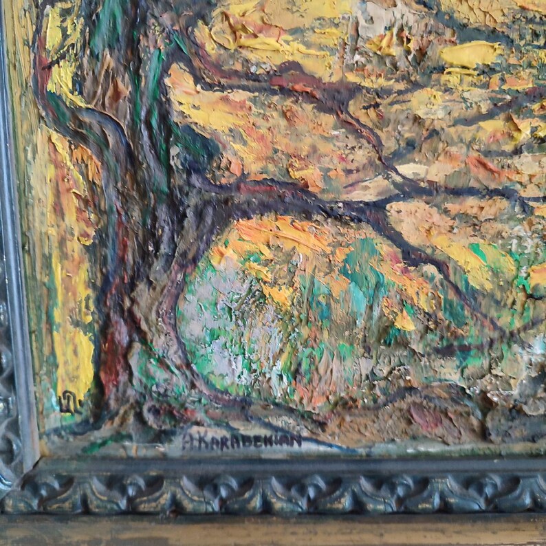 May include: A close-up of a framed oil painting depicting a landscape with a large tree in the foreground. The painting is done in a textured style with thick brushstrokes. The colors are mostly yellow, green, and brown. The artist's signature, "A. KARABEDIAN", is visible in the lower right corner of the painting.