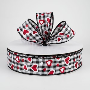 May include: Black and white gingham ribbon with red glitter hearts. The ribbon has a black edge.