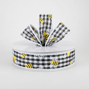 May include: A roll of decorative ribbon featuring a black and white gingham pattern. The ribbon is adorned with yellow cartoon bees and white decorative swirls. The ribbon is perfect for crafts, gift wrapping, and seasonal decor.