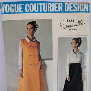 May include: Vintage Vogue Couturier Design sewing pattern featuring two women's fashion designs. The pattern includes a long, orange double-breasted coat and a black and white dress. The text "Simonetta of Italy" is also visible.