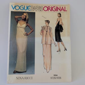May include: A Vogue Paris Original sewing pattern envelope for Nina Ricci design 1554. The front features a photograph of a floor-length cream gown and illustrations of a two-piece ensemble and a black dress. The text reads Vogue Paris Original.